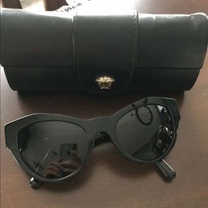 Versace woman cat eye black and gold sunglasses.
